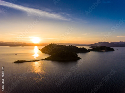 Aerial view of beautiful sunset in lake with small island photo