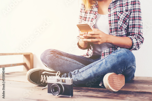 Young beautiful hipster woman with an old retro camera. © chaunpis