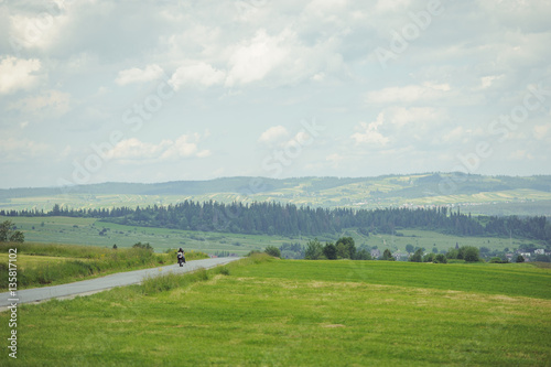 Hills covered with green grass under blue sky
