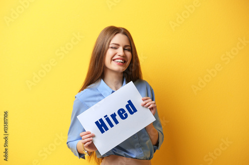 Woman holding paper with wo...
