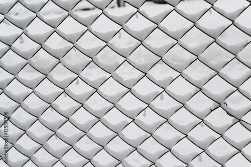 Fence from metallic net with snow