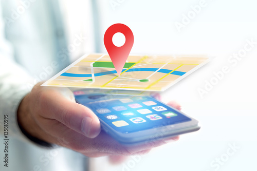 Vuiew of a Concept of geographical localization on a map with a smartphone photo