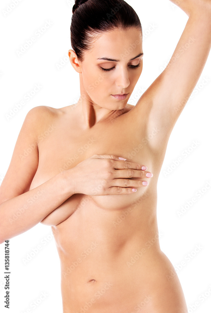 Topless woman covers her breasts with hands. Topless woman covers her breasts with hands.