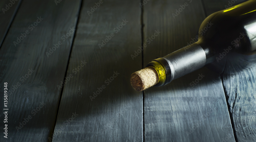 Bottle of wine in the old blue wooden background.