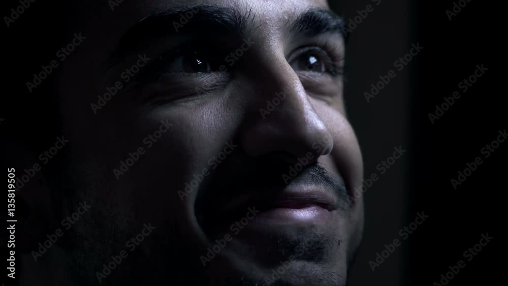 young man in darkness laughs and talks young man in darkness laughs and talks