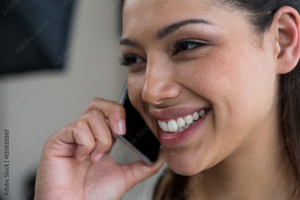 Female photographer talking on mobile phone Female photographer talking on mobile phone