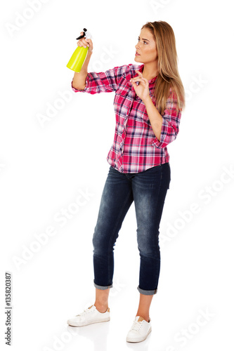Young woman holding a watering spray bottle