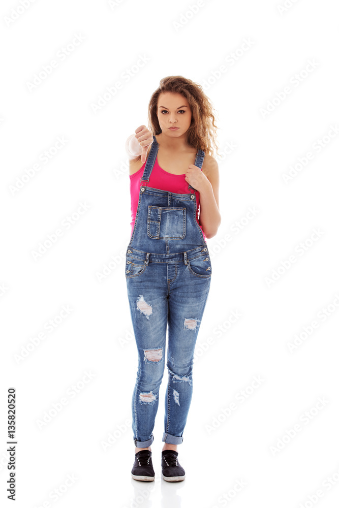 Young unhappy woman with thumbs down Young unhappy woman with thumbs down