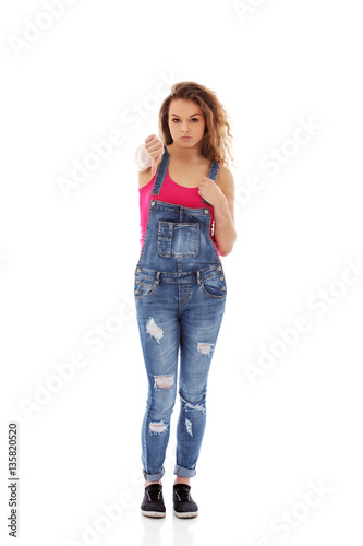 Young unhappy woman with thumbs down