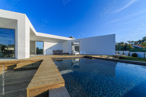 Modern house with garden swimming pool and wooden deck © Luis Viegas