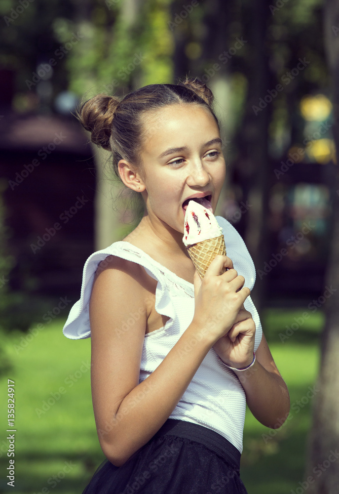 Girl eating ice cream in the park Girl eating ice cream in the park