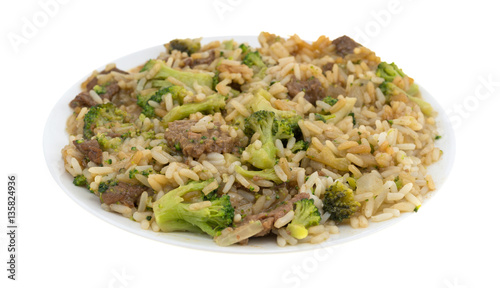 Beef broccoli and rice dinner on a plate isolated on a white background.