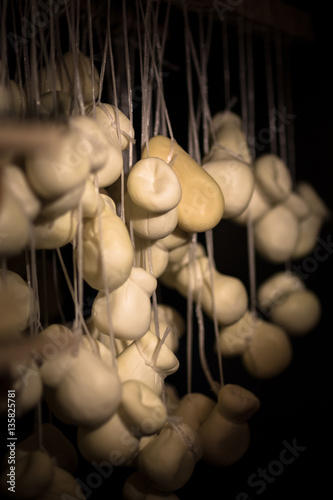 cheese at the dairy, scamorza cheese hanging matures