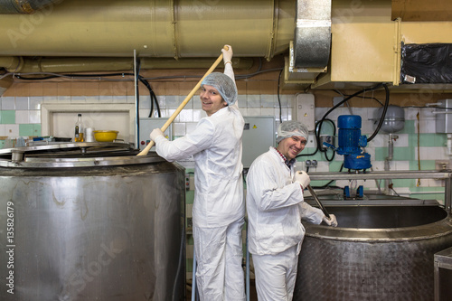 production of cheese in  dairy,  two worker photo