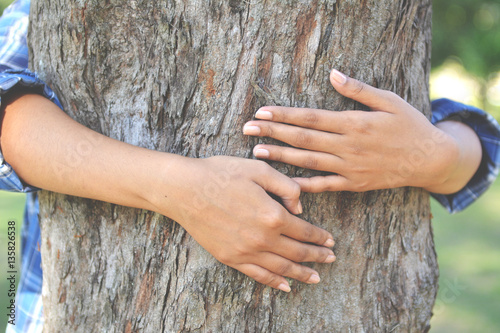 women hug big tree color of hipster tone selective soft focus, concept nature and people 