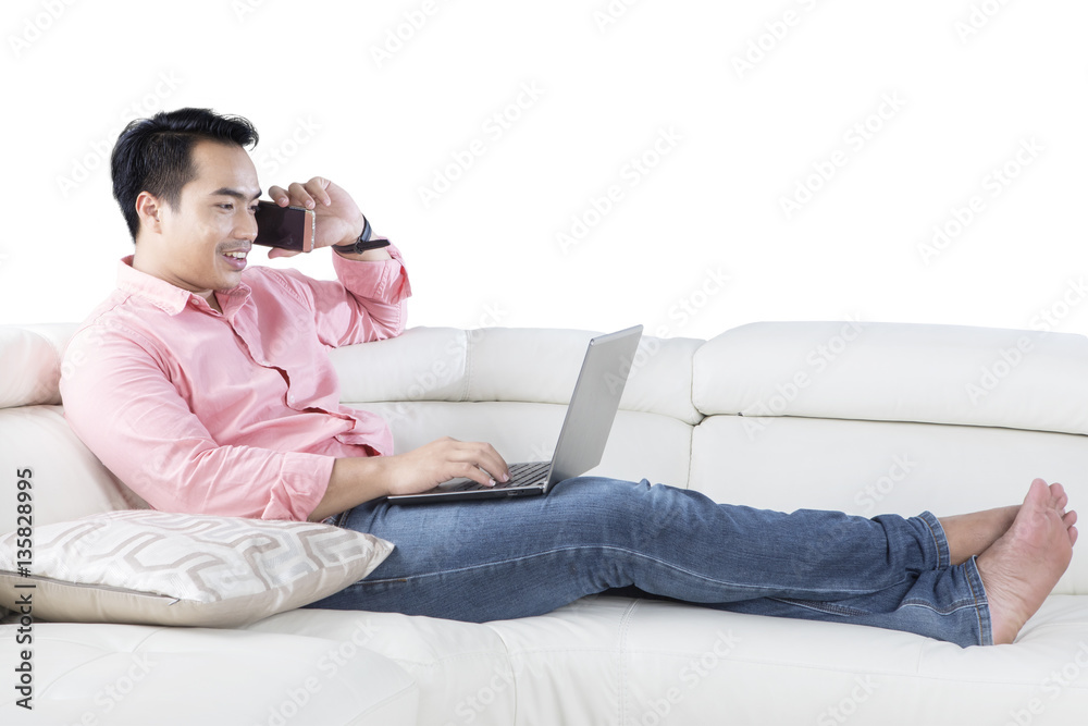 Asian person with laptop on couch