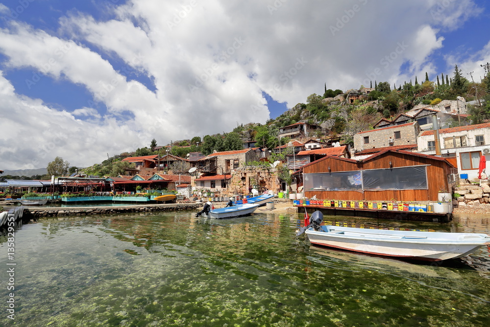 Fishing boats-pier-houses of Kaleköy-Castle Village. Ancient city of Simena-Lycia-Turkey. 1023