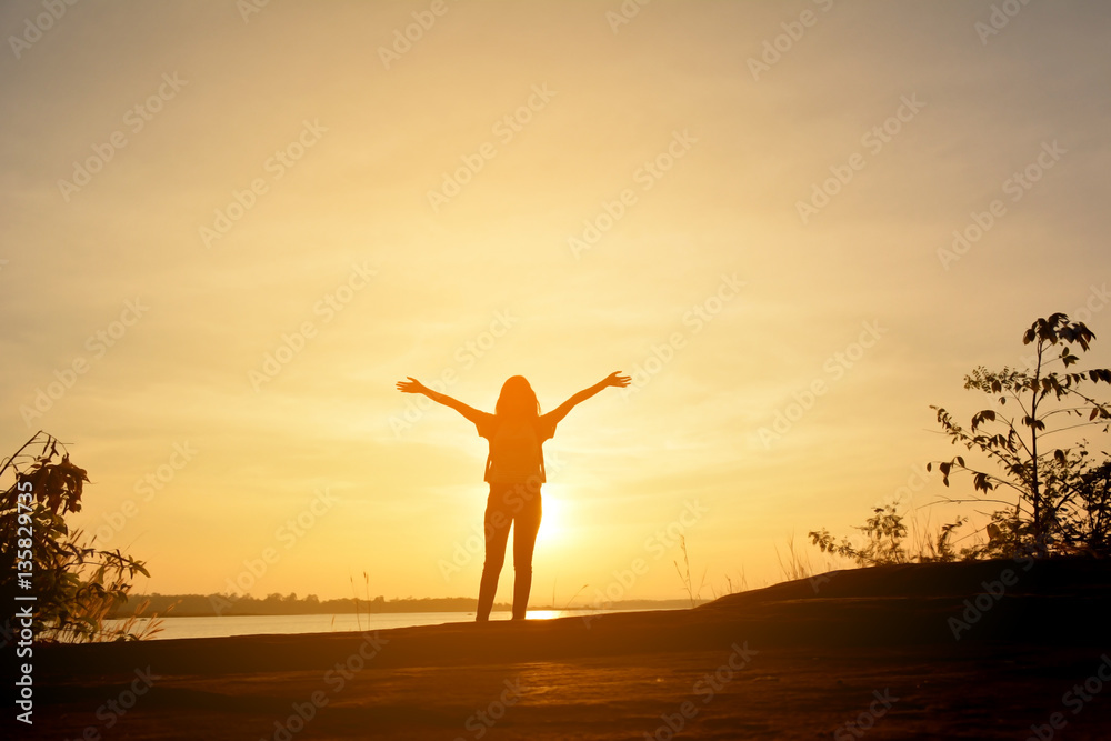 Fototapeta premium Silhouette of happy women relax in the nature concept travel at the sunset