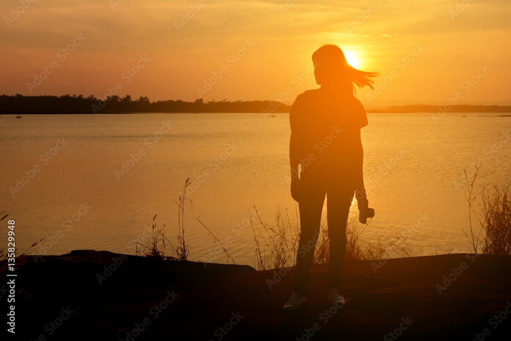 Fototapeta premium Silhouette of happy women relax in the nature concept travel at the sunset