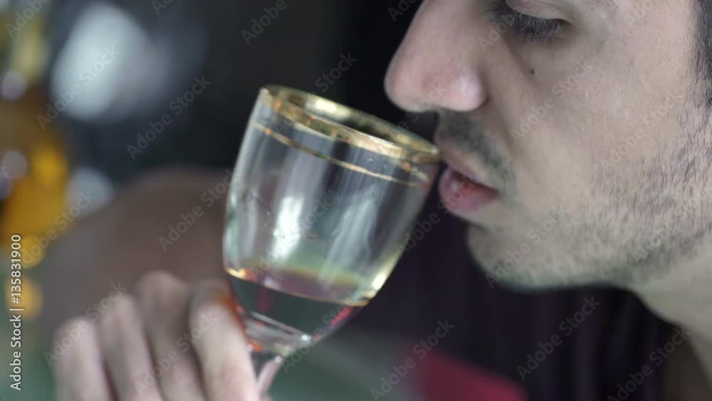 Profile of drunk man drinking a glass of liquor Profile of drunk man drinking a glass of liquor