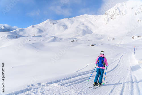 Young woman skiing on ski slope in Obertauern, Austria