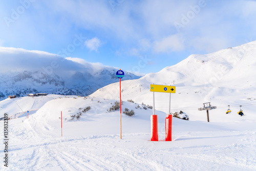 View of ski slopes in Obertauern ski area on sunny winter day with beautiful clouds, Austria © pkazmierczak