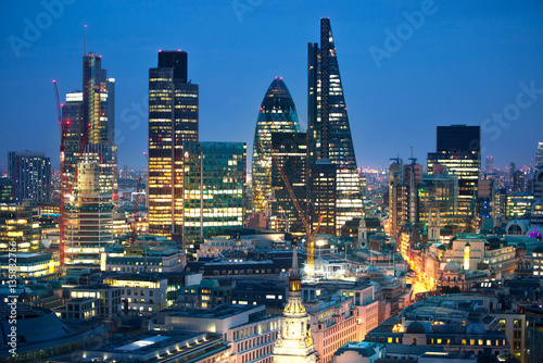 City of London at sunset with lights and reflection. View at the business and banking aria with modern skyscrapers 