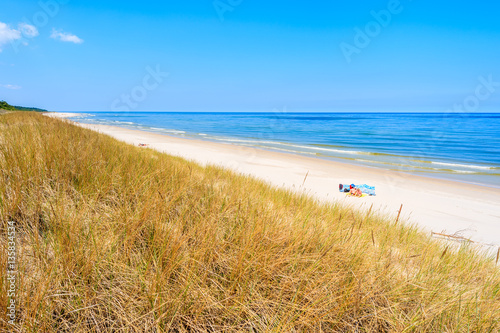 Fototapeta Naklejka Na Ścianę i Meble -  Grass sand dune and beach view in Lubiatowo, Baltic Sea, Poland