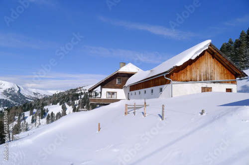 Typical houses with covered by fresh snow roofs in Schonfeld village, Salzburg land, Austria