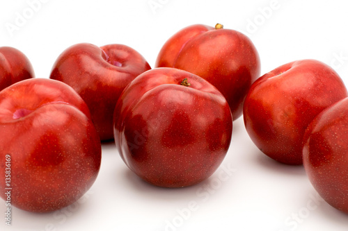 ripe plums on a white