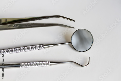 metal dental tools on isolated background