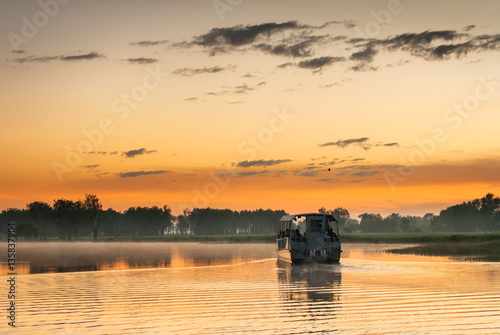 Boat on Yellow Water billabong at dawn, Northern Territories, Australia photo