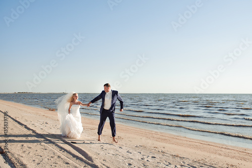 couple in love on the beach on their wedding day © nagaets