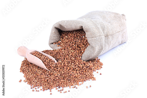 Buckwheat in sack with wooden scoop