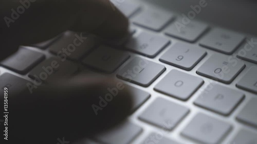 very close Close-up hands typing password on keyboard in office - business people, smooth tracking shot photo