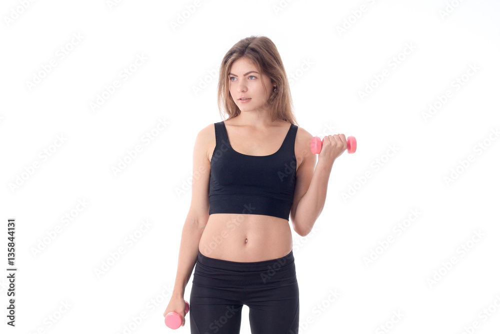 girl standing right turning his head to the side and holding little pink dumbbells girl standing right turning his head to the side and holding little pink dumbbells