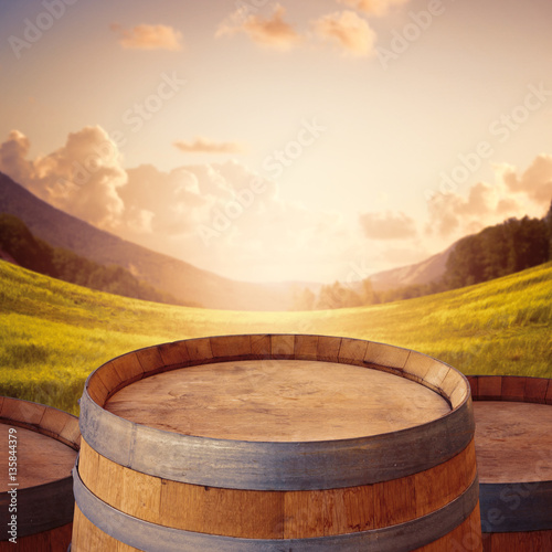 Wooden barrel over beautiful landscape background for product montage display