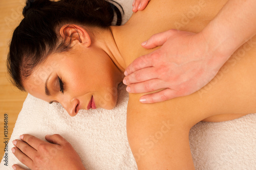 Beautifulyoung woman having a rejuvenating massage in a wellness