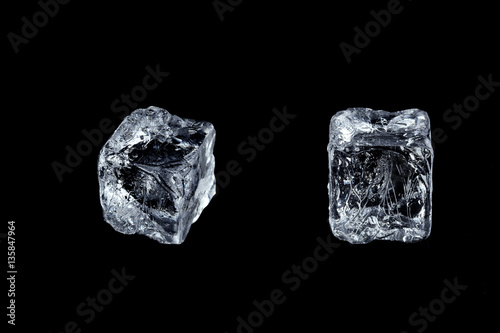two ice cubes on black background