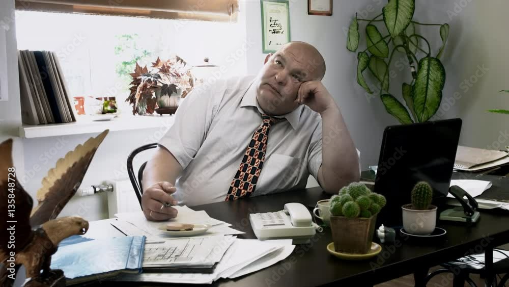 Boss Desk / Manager Office / Boss Doing Nothing / Creative Thinking / No Ideas. Funny fat chief is out of ideas. Man puts the paper sheet aside and begins to dream in the workplace.