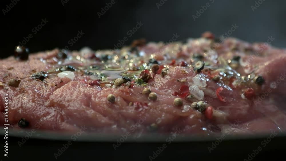 Raw steak and spices. Meat with oil on pan. Cook a dish from beef. Raw steak and spices. Meat with oil on pan. Cook a dish from beef.