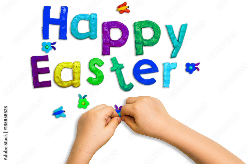 children's hands and words fashioned from clay Happy Easter on a white background children's hands and words fashioned from clay Happy Easter on a white background