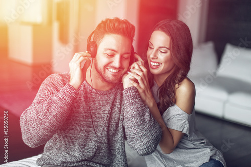 Canvastavla Young couple listening music indoor