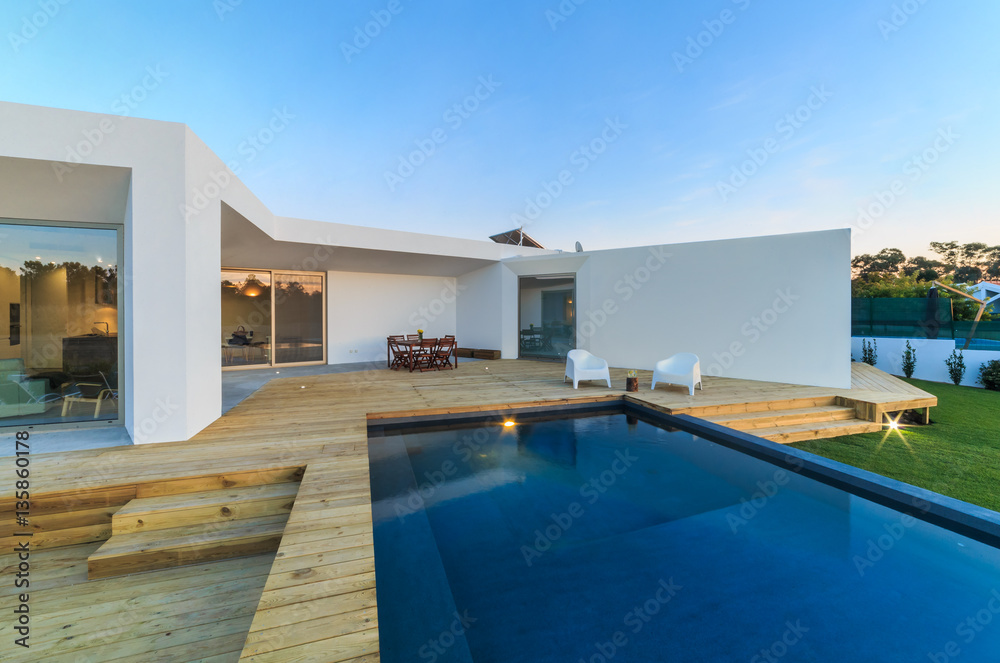 Fototapeta premium Modern house with garden swimming pool and wooden deck