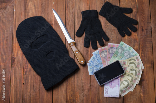 black mask with a gun crime on the table