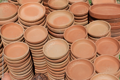 Plates of red ceramic. Background of ceramic cups