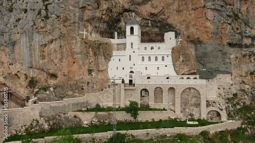 Buildings cut in cliff of Ostrog Monastery (the Serbian Orthodox Church). Front view. Montenegro
