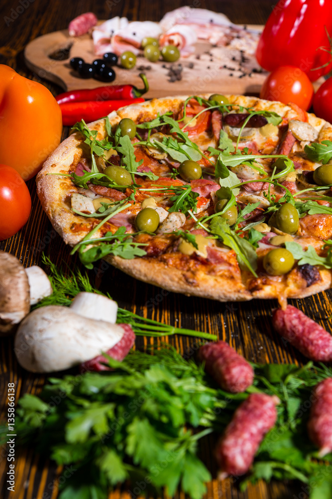 Delicious pizza on wooden table surrounded by vegetables