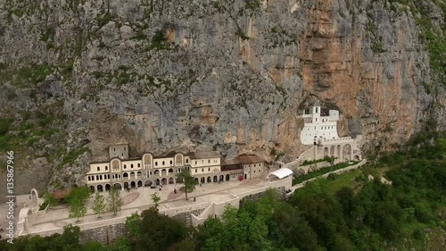 Flying in front of monastery of Ostrog in the large rock of Ostroska Greda, Montenegro. Aerial view
