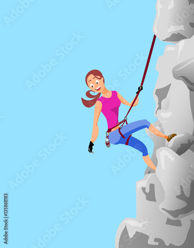 Climber brunette girl clings to the safety belts on a cliff.